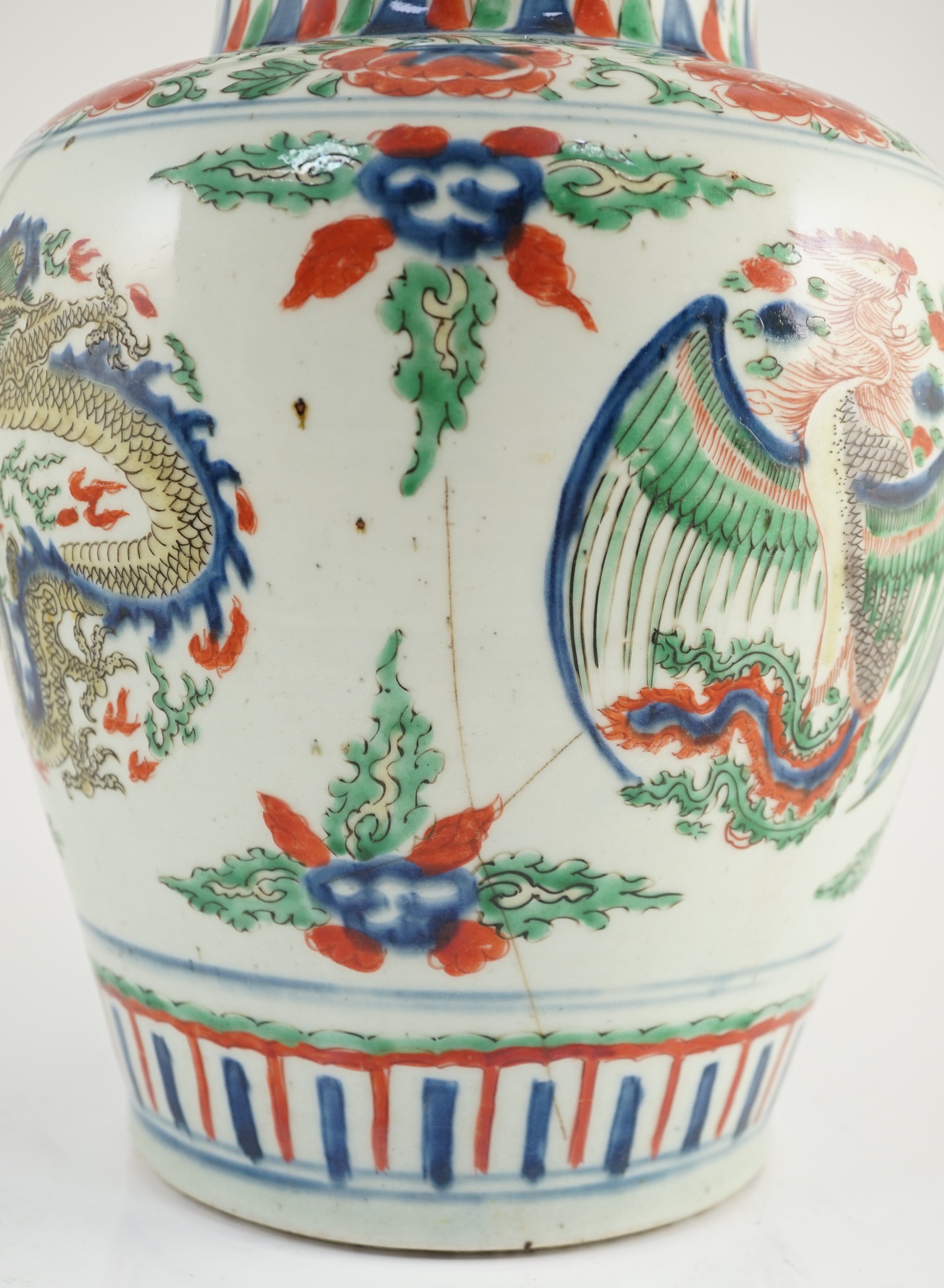 A Chinese Transitional wucai ‘dragon and phoenix roundel’ vase, 17th century, 30cm high, cracks